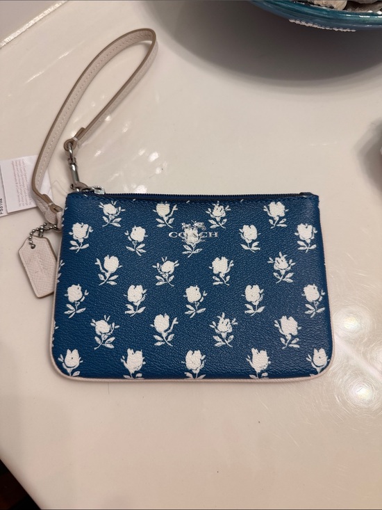 Coach Handbags - Coach Navy Floral Print Wristlet with Cream Strap